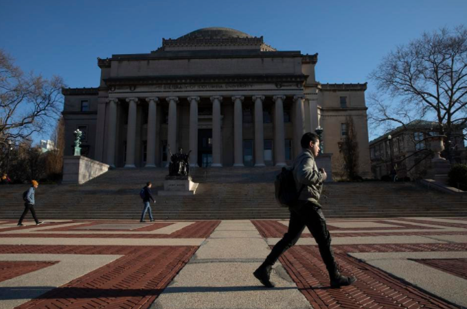 A man walks past Low Library on the Columbia University campus,