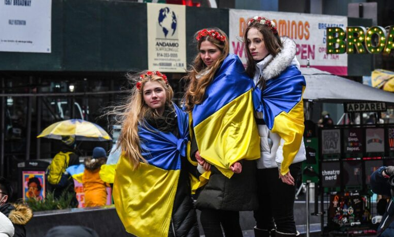 Demonstrators wear the Ukrainian flag while protesting against Russia's invasion of Ukraine in the Times Square neighborhood of New York, U.S., on Saturday, March 12, 2022.