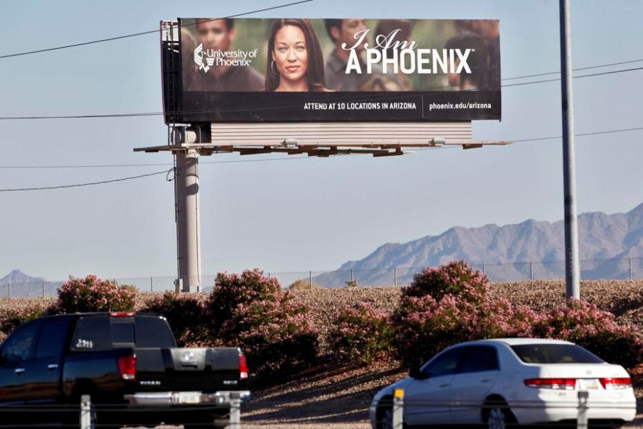In this Nov 24, 2009 file photo, a University of Phoenix billboard is shown in Chandler, Ariz. The Department of Veterans Affairs is moving to bar new GI Bill students from enrolling at five universities, including the University of Phoenix, citing "advertising, sales or enrollment practices that are erroneous, deceptive or misleading.”