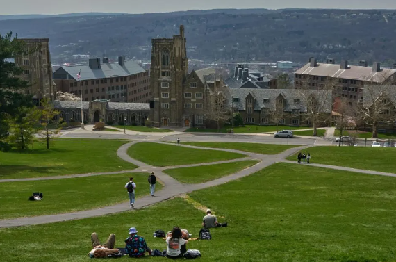 Students on Libe Slope at the Cornell University campus in Ithaca, US, on Tuesday, April 11, 2023. US college costs just keep climbing and the increase is pushing the annual price for the upcoming academic year at Ivy League schools toward yet another hold-on-to-your-mortarboard mark. Photographer: Bing Guan/Bloomberg
